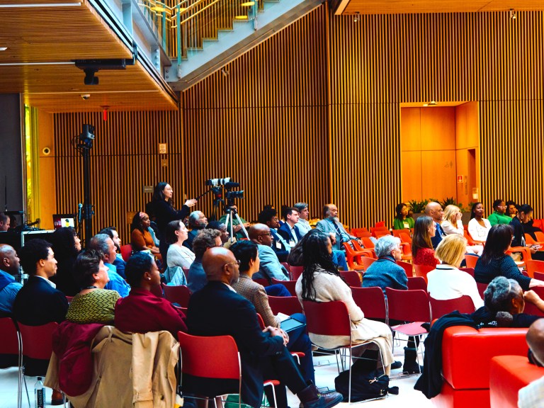 An audience at an event, everyone is looking forward