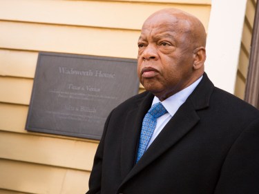 Congressman John Lewis in front of a plaque