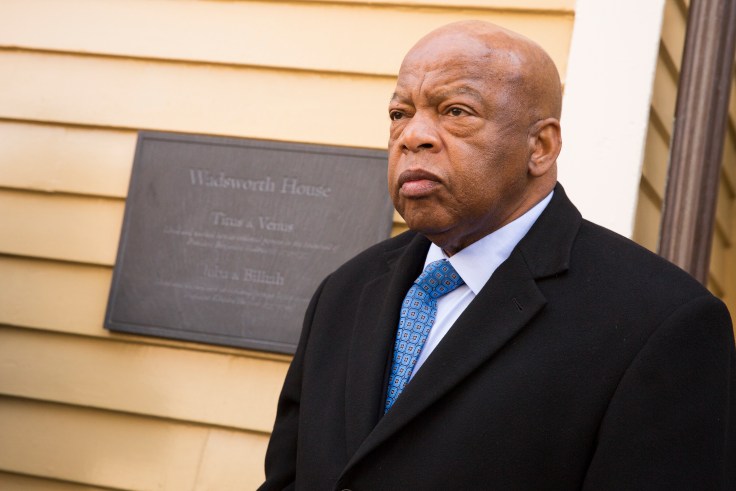 Congressman John Lewis in front of a plaque