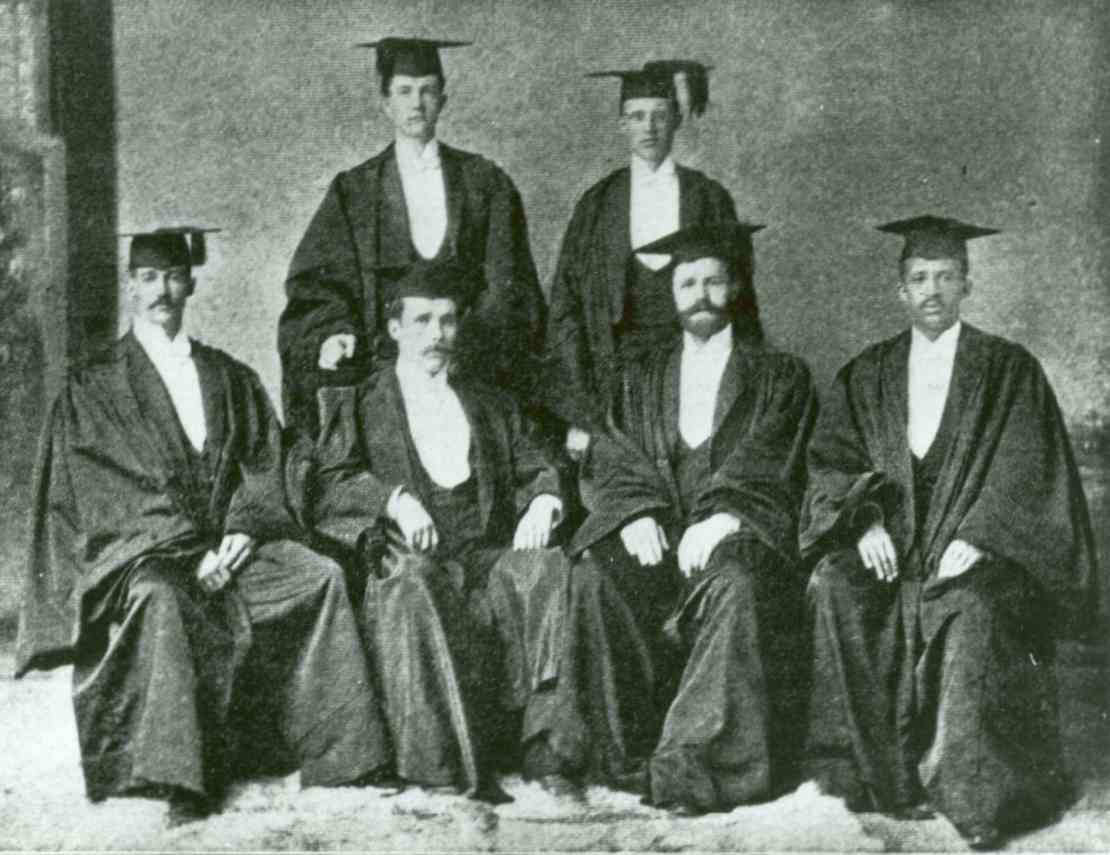 A black and white photos of 6 people in cap and gown