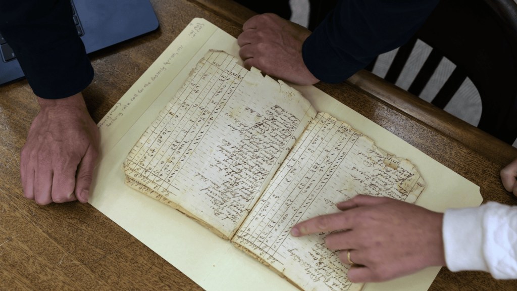 An older looking document being reviewed