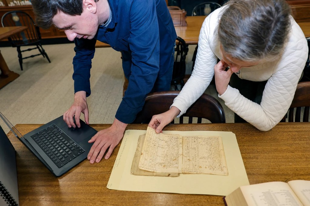 Two researchers reviewing documents